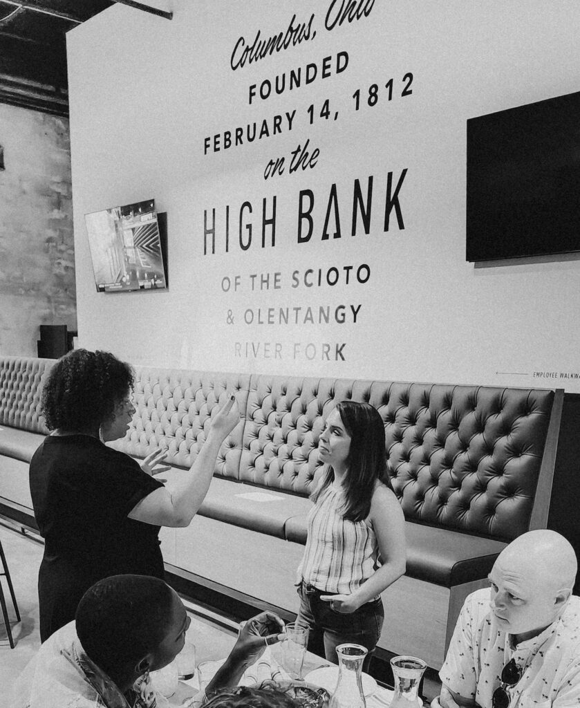 Haven Collective Happy Hour at High Bank Distillery with people talking to one another